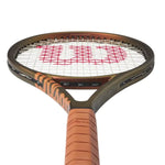 Alt Text: Detailed view of the grip of the Wilson Pro Staff Team V14 tenis racket, illustrating its comfortable hold for effortless play. Browse at ProBadminton.in.