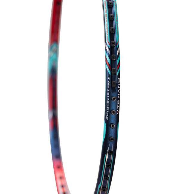The Li-Ning Aeronaut 9000 racket is shown resting on a badminton court with a shuttlecock nearby. The image frames the racket in a ready-to-play context, emphasizing its professional use and sleek aesthetic against the court's background.








