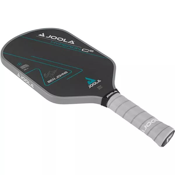 Hyperion C2 CFS 16 resting on court net: "The Joola Ben Johns Hyperion C2 CFS 16 Paddle artfully placed on the pickleball court net."